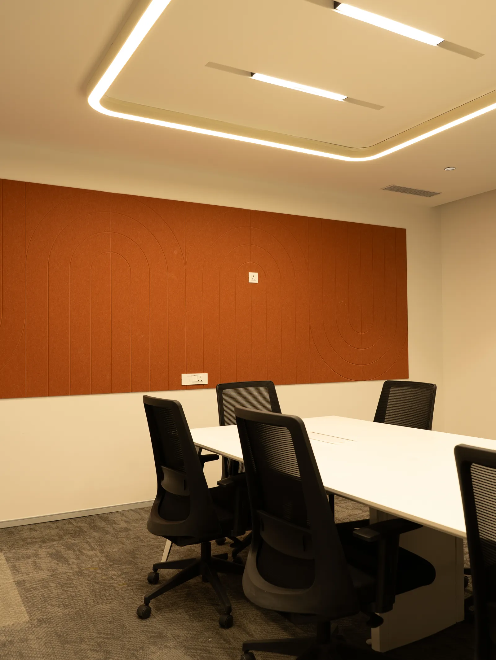 Meeting room with white table and black chairs — Moschip